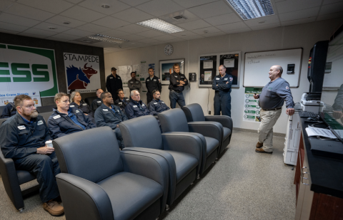 The delegation receives a briefing on critical safety protocols designed to protect the operators and the environment surrounding the platform.